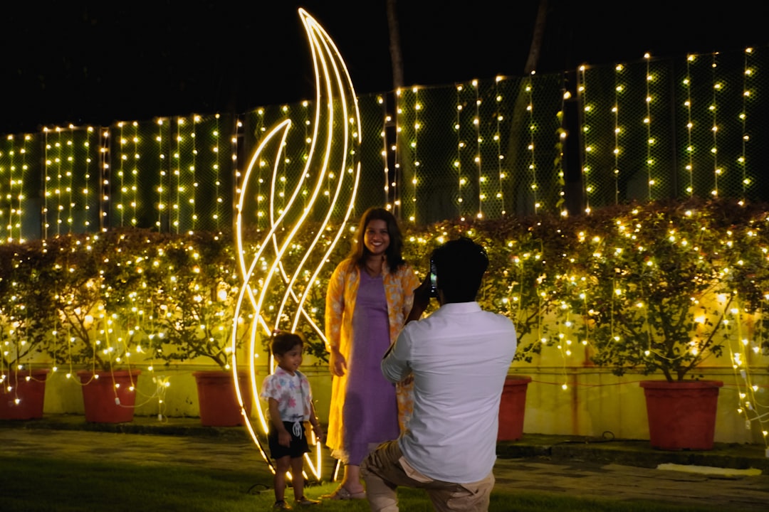 Couple posing for a photo with festive lights