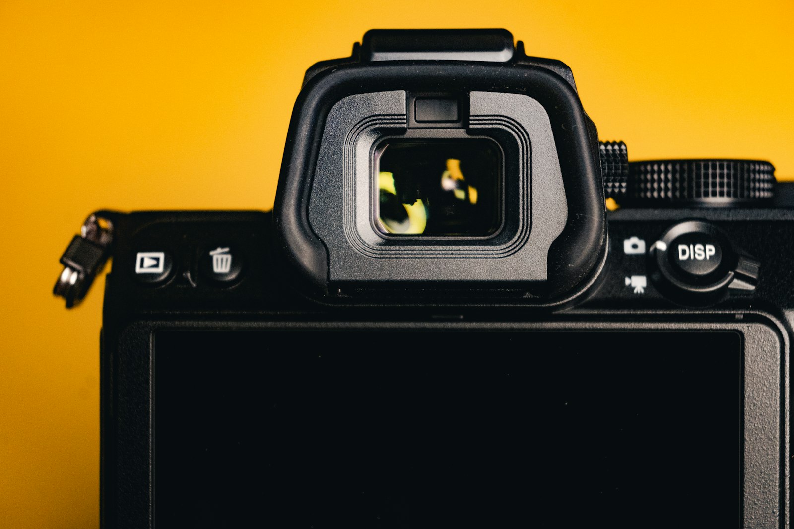 Mirrorless camera flatlay on a yellow background