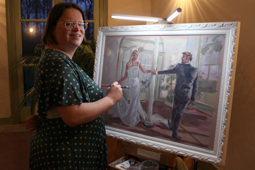Artist painting a wedding portrait of a couple
