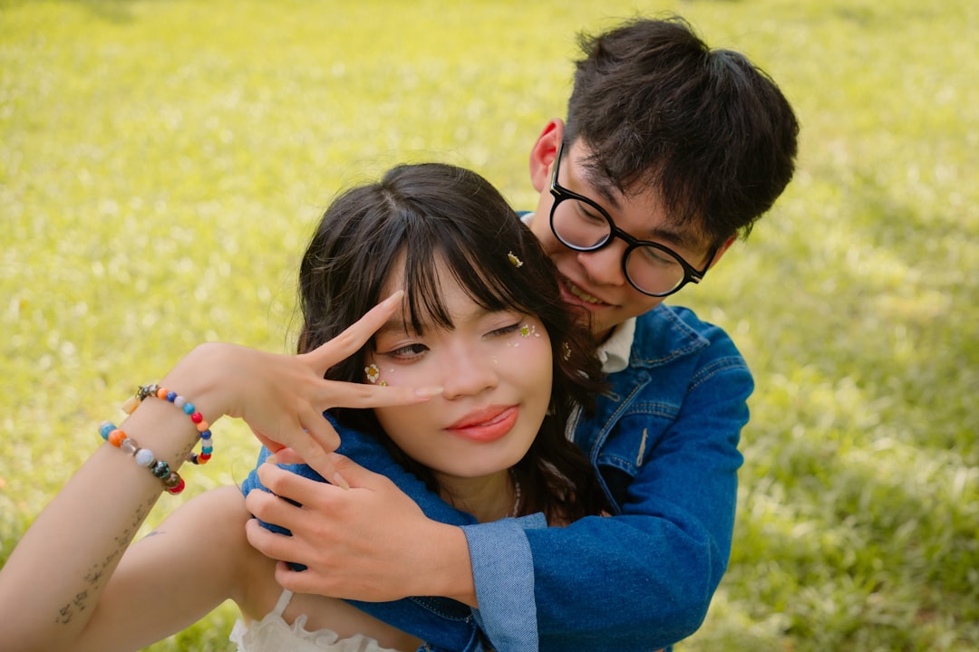 Young couple embracing in a grassy field