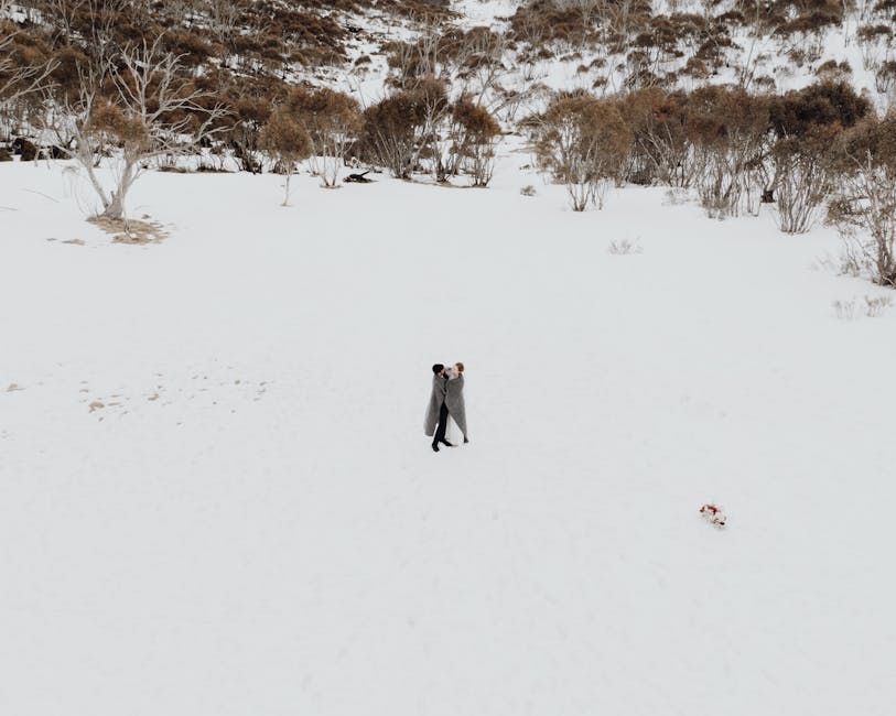 A romantic couple embracing in a snowy landscape, symbolizing love and intimacy.