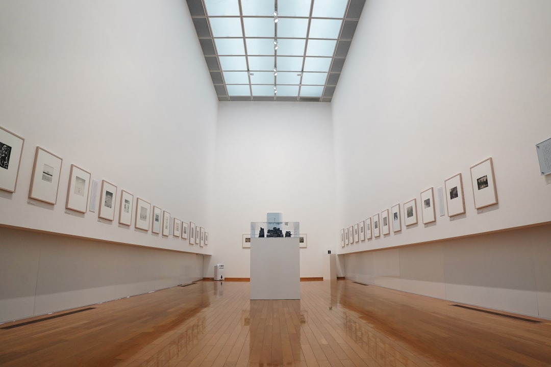 Art gallery with framed works on white walls