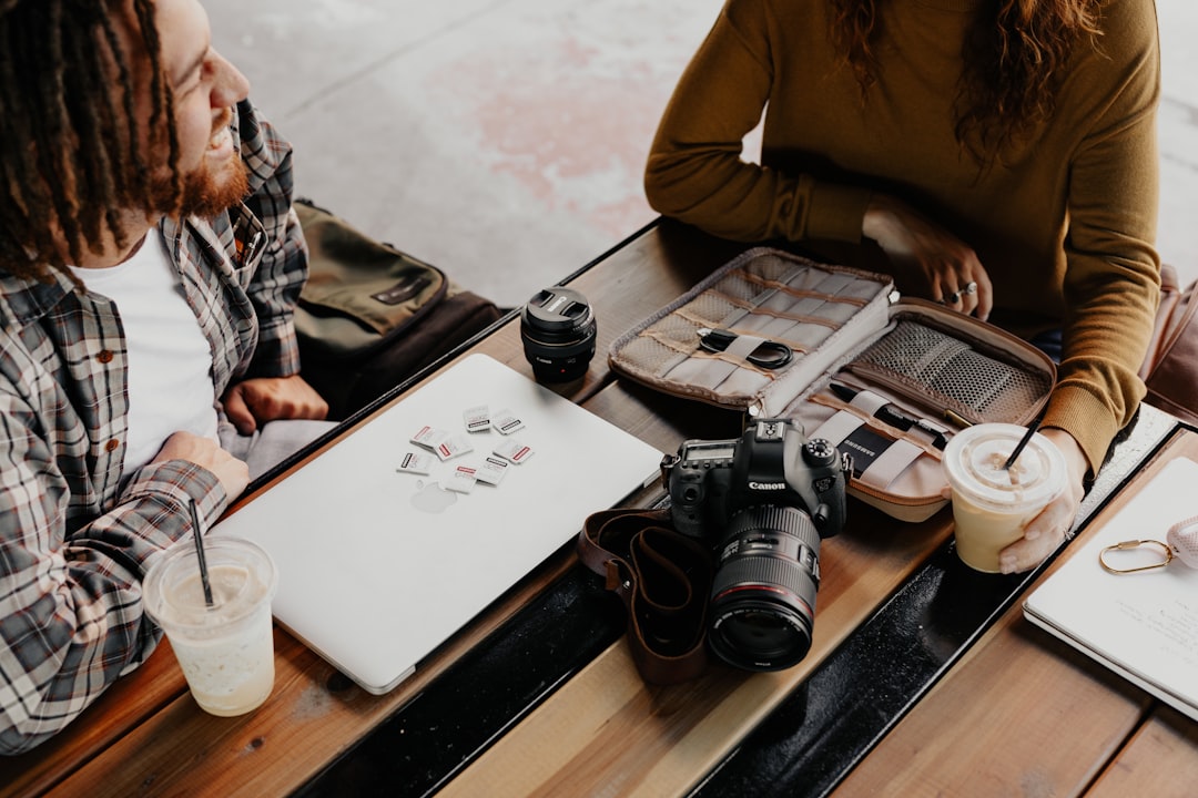 black dslr camera on brown wooden table