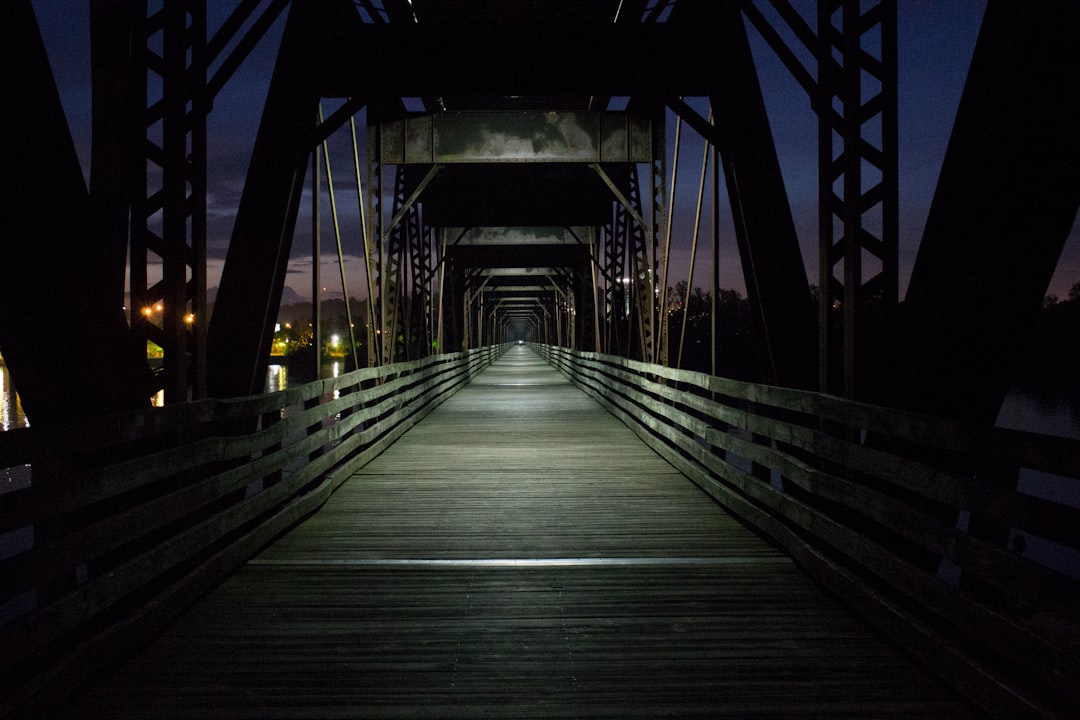 alley photography of bridge during nighttime