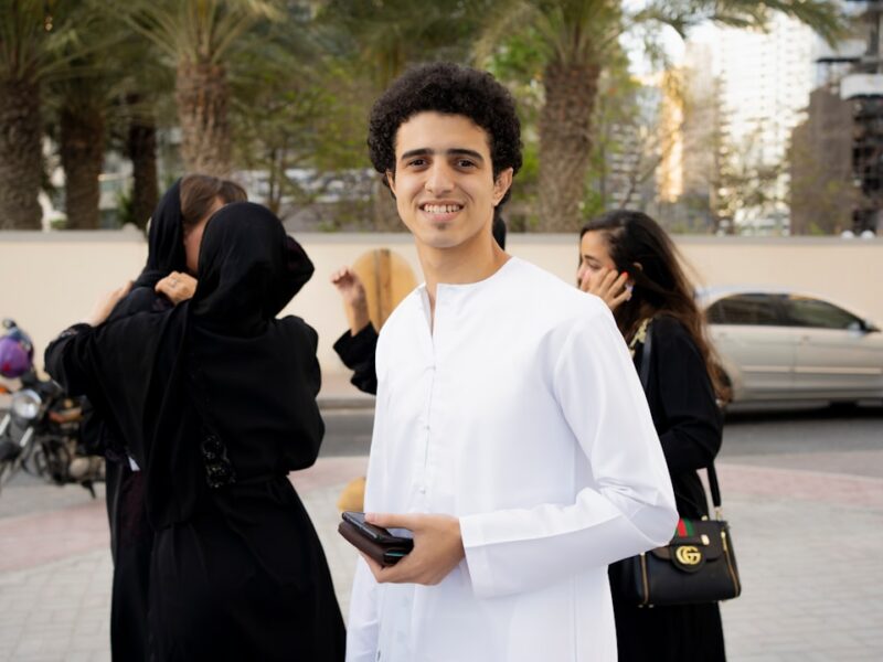 a man in a white outfit standing next to a woman