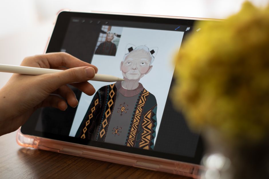 Artist restyling a portrait on a tablet with a stylus