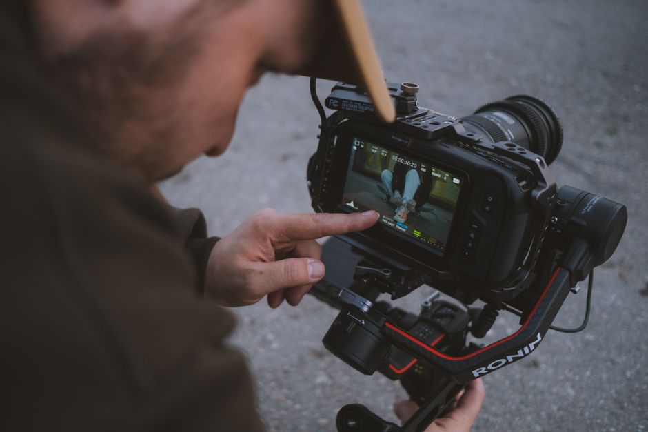 Camera operator reviewing video footage on a monitor